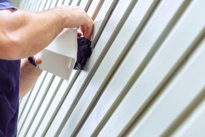 man cleaning a Dryer-Vent install