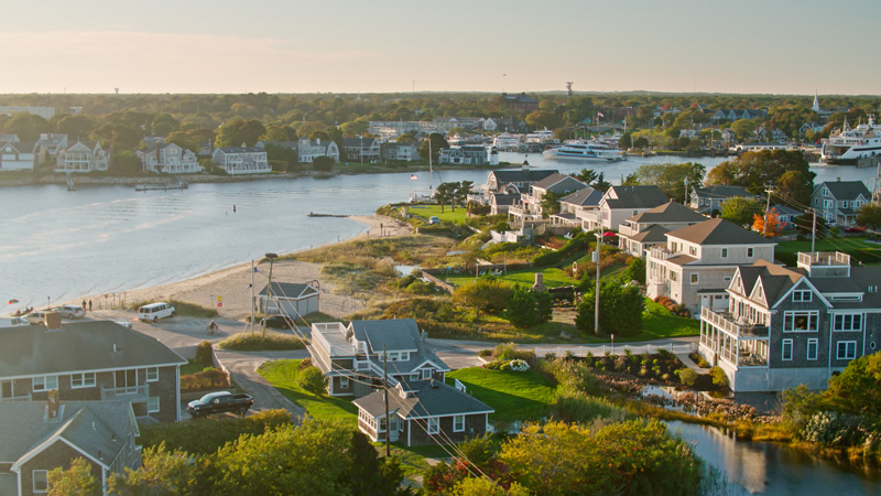 Aerial view of coastal town by the water at sunset.