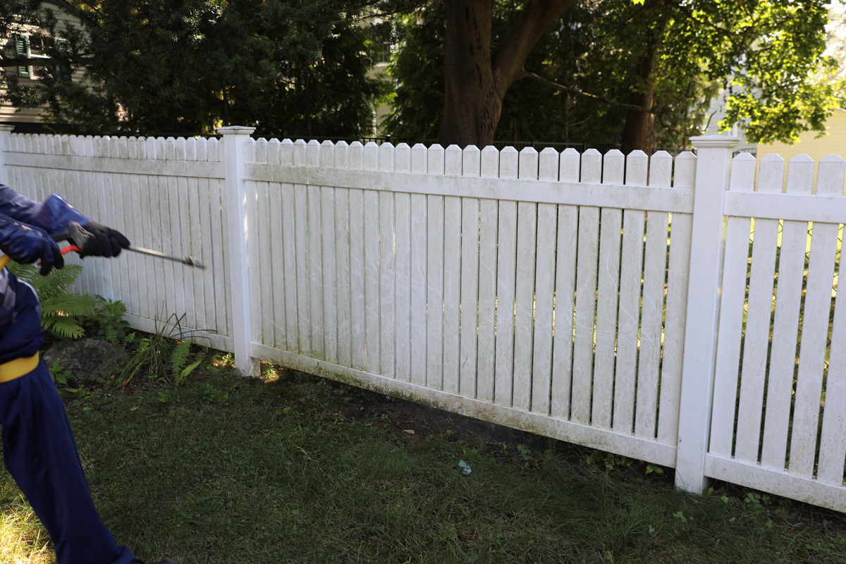 white fence being power washed