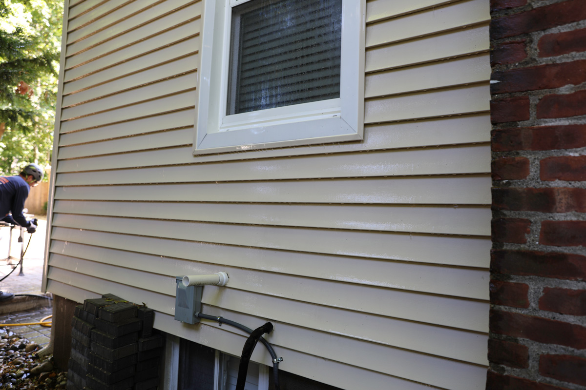 power-washing on a clean house siding after