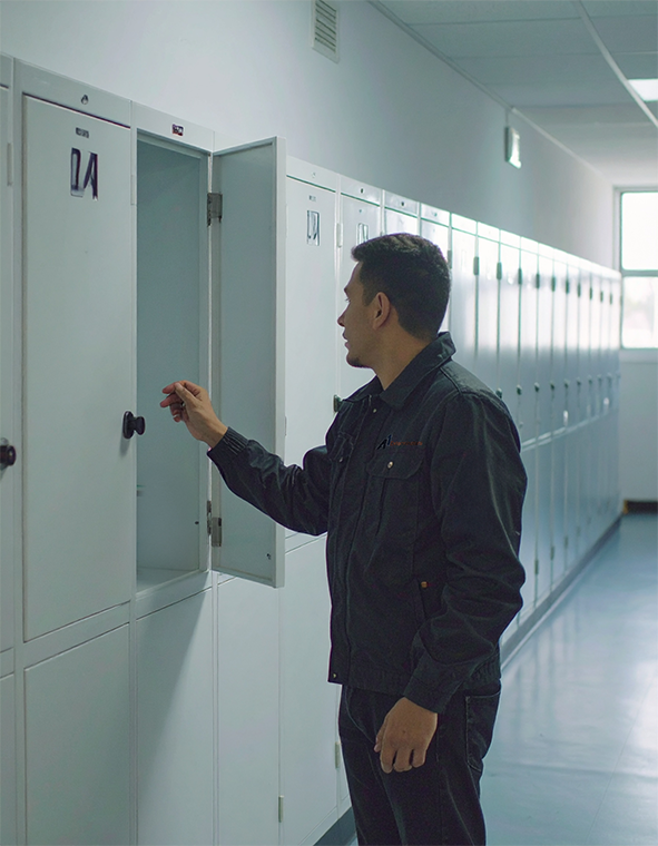 man inspecting lockers at a school